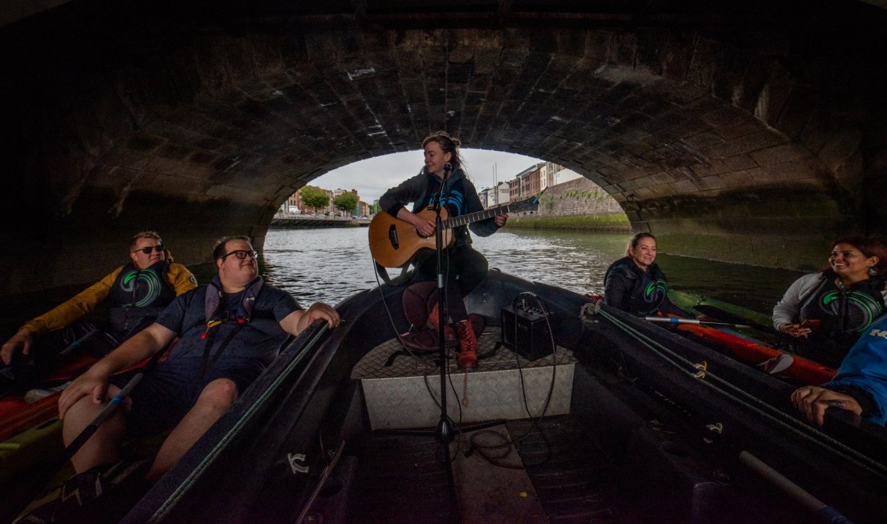 woman playing guitar on a boat 